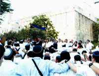 Visitors dancing around Machpela Cave in Hebron