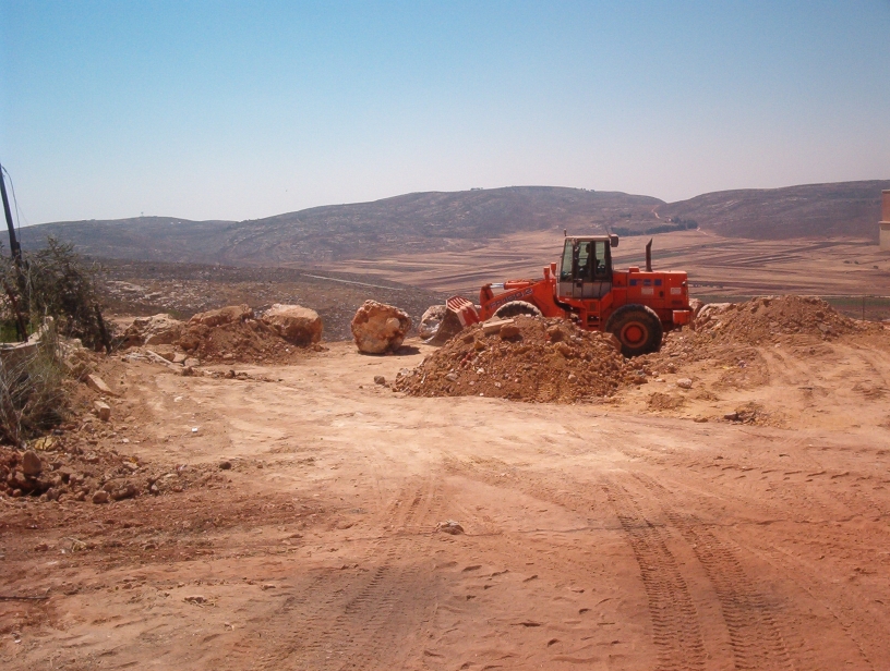 Leveling landfill between boulders